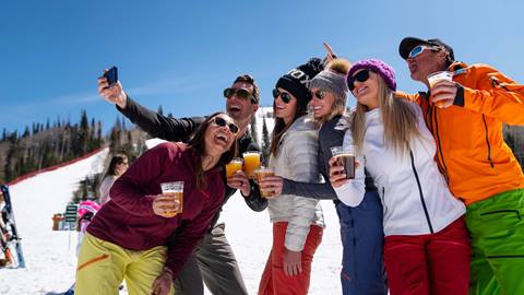 Friends taking selfie and drinking at Silver Lake beach.