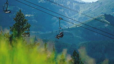 Guests riding chairlift in the summer at Deer Valley