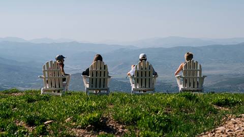 Guests sitting outside on lawn chairs at Deer Valley