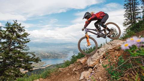 Man mountain biking with a view of the Jordanelle Reservoir at Deer Valley.