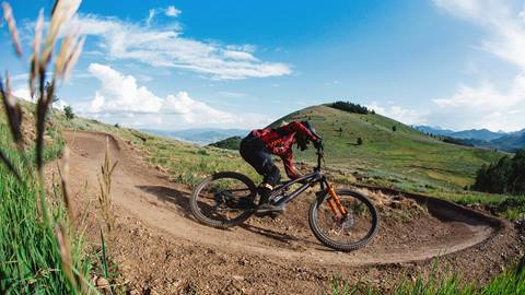 Man mountain biking with scenic views