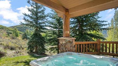 Hot tub outside Deer Valley Lodging Property 3020 Thistle in the summer.