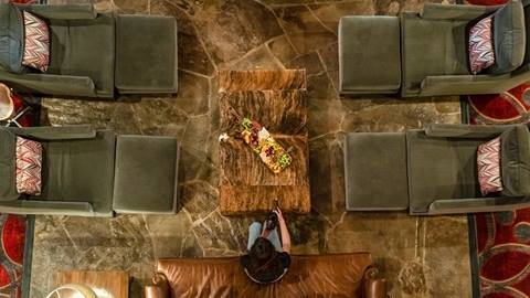 Guest enjoying après-ski in the lobby at Silver Baron Lodge.