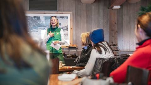 Deer Valley Ski Instructor talking to a group of women inside Snow Park Lodge.