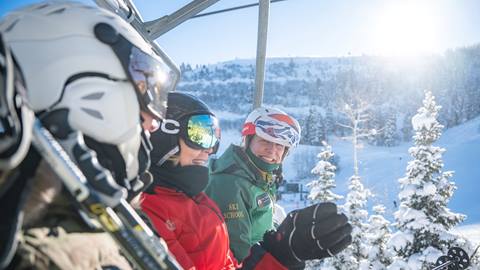 Women on chairlift with Deer Valley ski instructor.