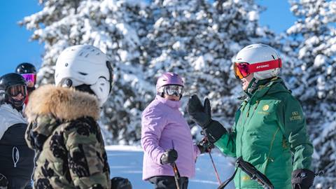 Deer Valley ski lesson instructor teaching a group of women.