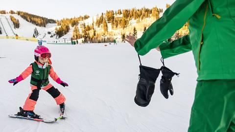 Deer Valley ski instructor teaching young girl to ski.