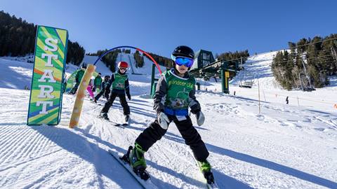 Kids group skiing during ski lesson at Deer Valley.