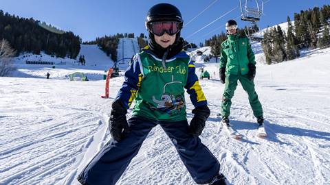 Young boy learning to ski with Deer Valley Ski Instructor.