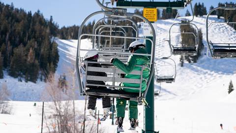 Girl riding chairlift with Deer Valley Ski Instructor.