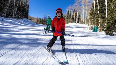 Deer Valley ski instructor teaching boy.