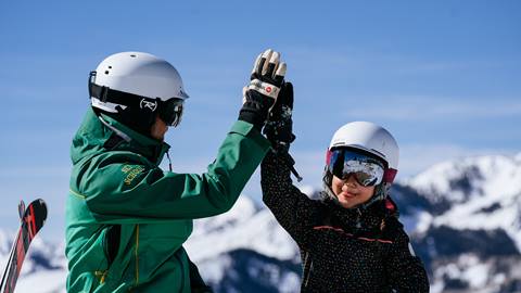 Deer Valley ski instructor giving high five to girl in a private ski lesson.