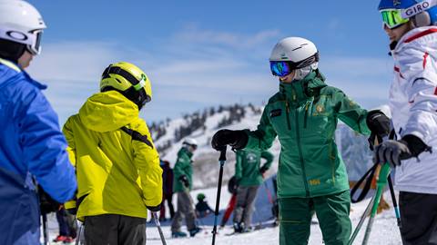 Deer Valley Ski Instructor talking to a group of teenagers.