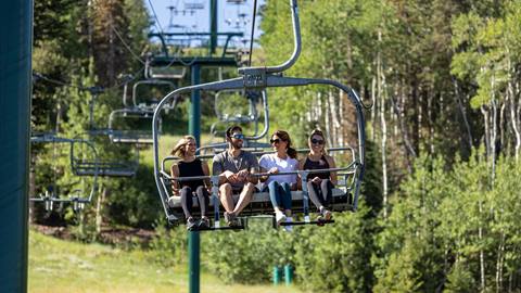 Friends taking scenic chairlift ride at Deer Valley.