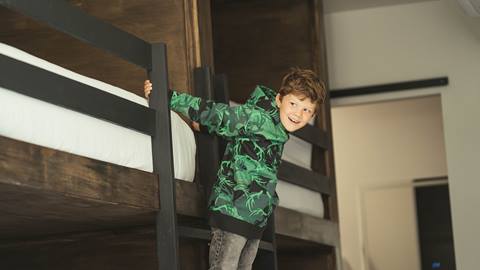 Young boy wearing green Deer Valley hoody.