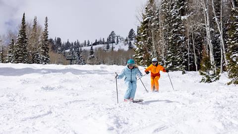 Jillian Vogtli and Fuzz Federson skiing together at Deer Valley.