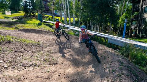 Two kids mountain biking at Deer Valley