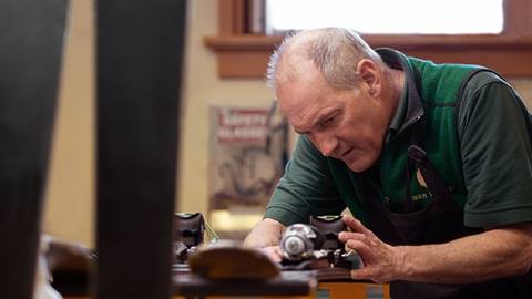 Deer Valley ski rental technician tuning skis.