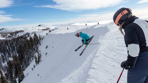 Guests skiing off top of ski run at Deer Valley.