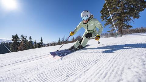 Woman skiing groomed run at Deer Valley.