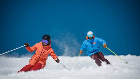 Couple skiing powder at Deer Valley.