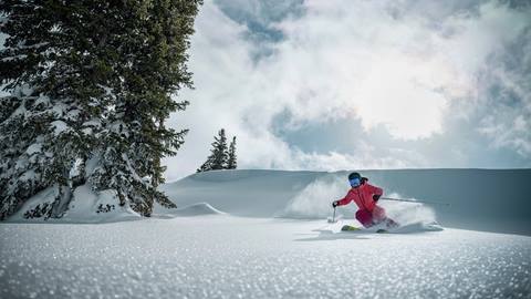 Woman skiing on a powder day at Deer Valley.