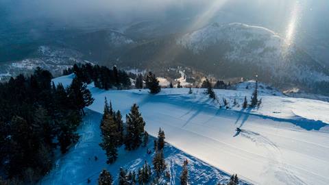 Skier enjoying groomed run at sunrise at Deer Valley.