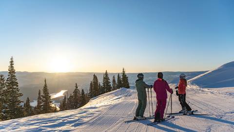 Guest skiing in Deer Valley's Expanded Terrain during sunrise.