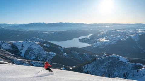 Guest skiing in Deer Valley's Expanded Terrain with a scenic view.