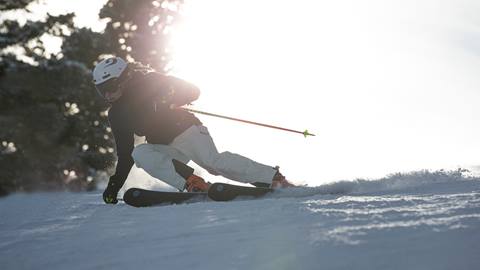 Woman skiing Deer Valley at sunrise.