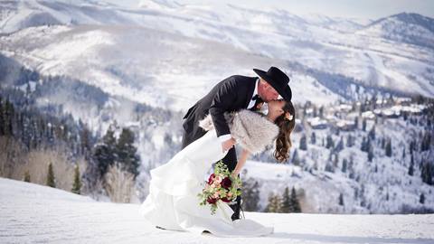 Married couple kissing at Deer Valley wedding venue in the winter.